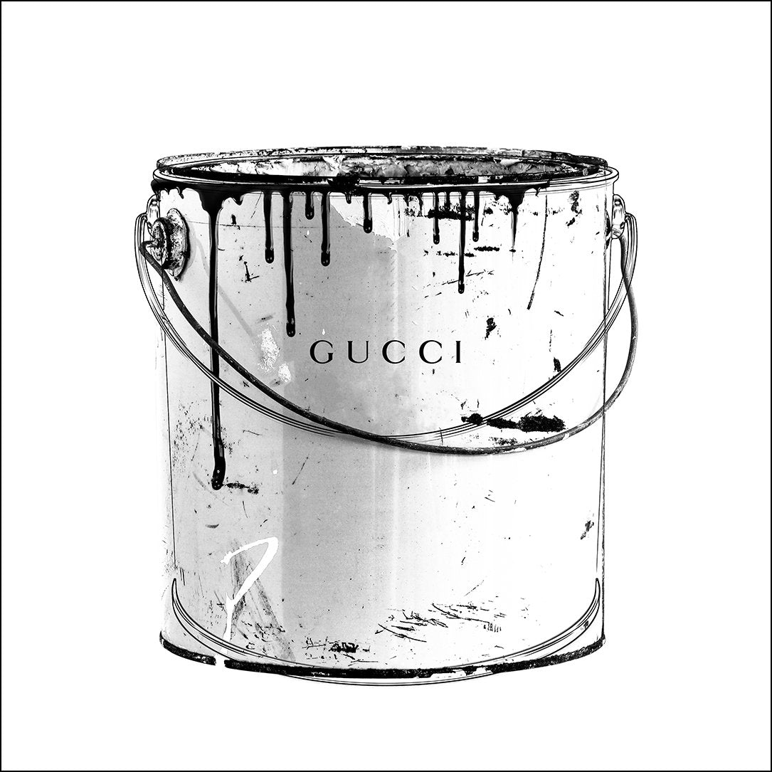 A black and white fashion wall art with a paint jug and Gucci fashion label wrinting on it. 