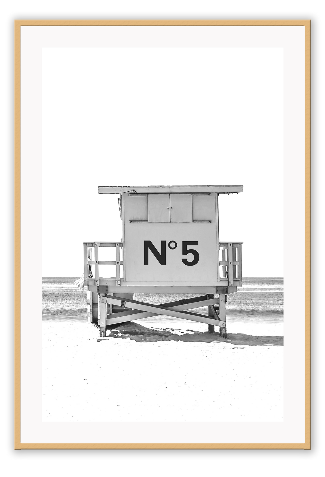 A black and white fashion wall art with black Chanel N5 fashion label on a beach cabin minimal