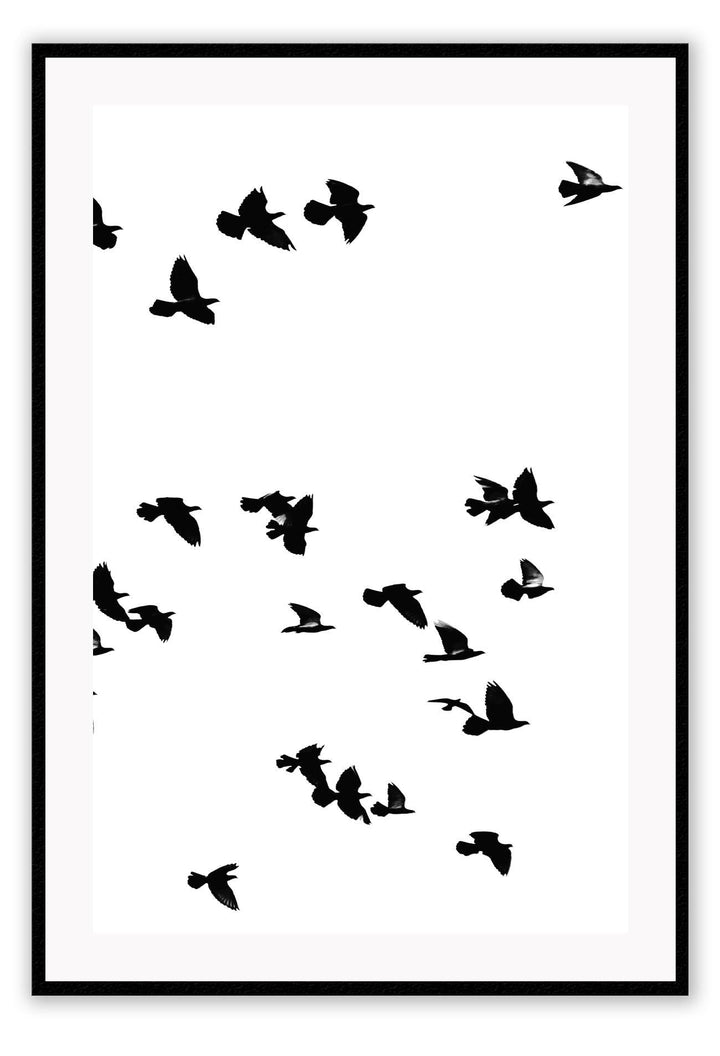 A black and white wall art with black sky birds in white sky. 