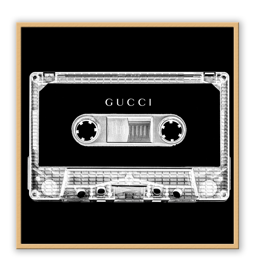 A vintage fashion wall art with Gucci fashion label on 80s 90s vintage cassette tape in fluro black and white inverted colour.