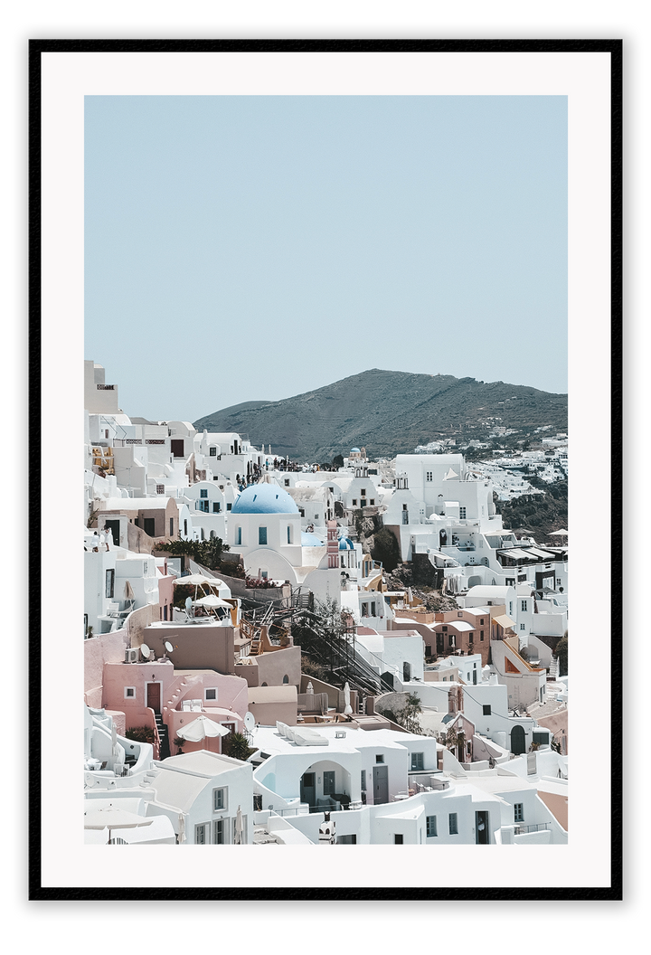 Greece, coastal architecture pastel colours blue sky mountain in background