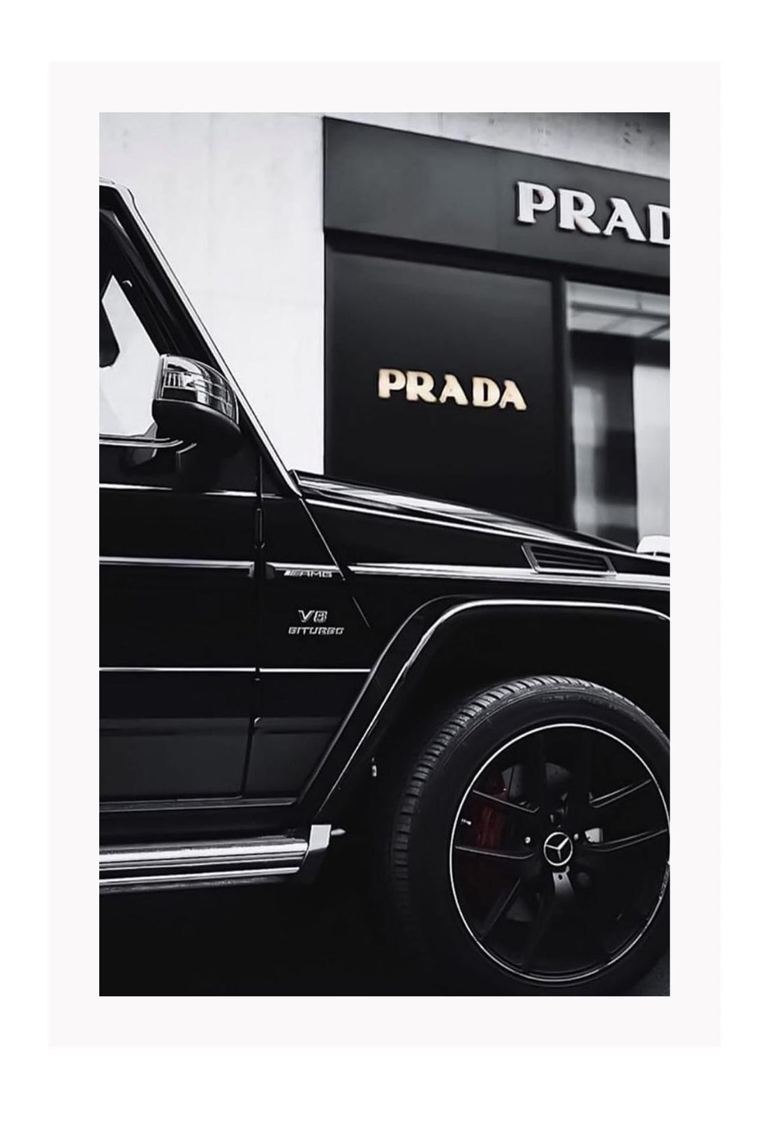 Fashion black and white photography print of a black Mercedes G Wagon in front of a Prada store.